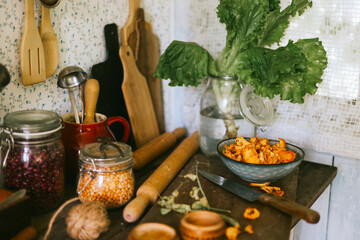 veranda of country village house with vegetables and chanterelle mushrooms on wooden table, eco-friendly food from garden, autumn harvesting