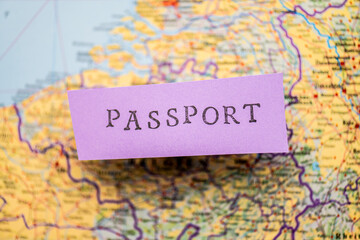 Passport stencil text on purple paper over a map.