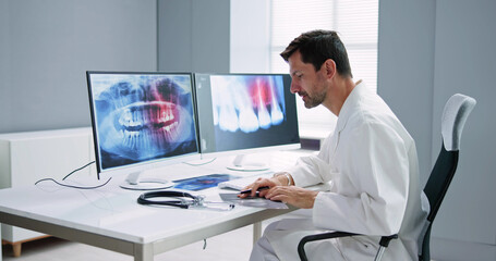 Fototapeta na wymiar Radiologist Dentist Using X Ray Software