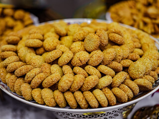 Many hazelnut cookie on white plate.