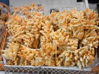 Traditional Lithuanian cake Sakotis or bankuchen is baked outside on a campfire in a metal oven, constantly turning the spit