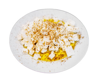 Fresh feta cheese full of olive oil and oregano white isolated