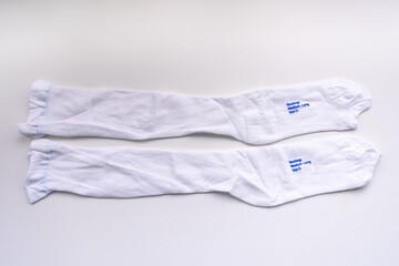 A pair of compression stockings isolated in white for hospital patients undergoing surgery to...