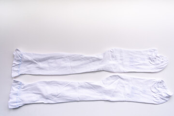 A pair of compression stockings isolated in white for hospital patients undergoing surgery to prevent blood clots and deep vein thrombosis.