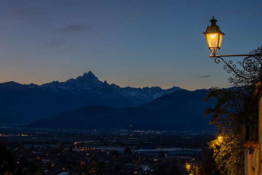 il profilo del monviso si staglia all'orizzonte durante il tramonto a saluzzo, caratteristico borgo del cuneese