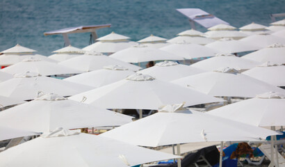 White umbrellas on the beach as a background