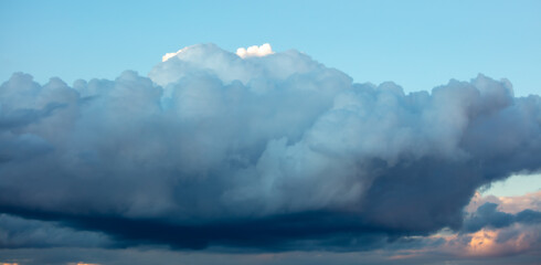 Rain clouds at sunset as background