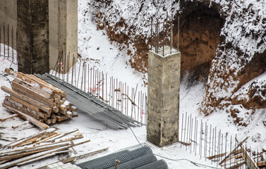 Concrete blocks for the foundation in the snow in winter at a construction site