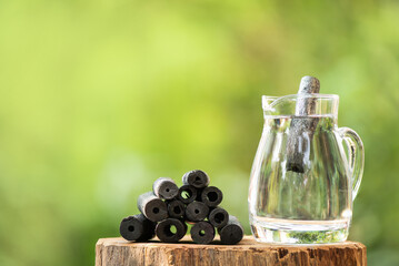 Charcoal soaked in drinking water on nature background.