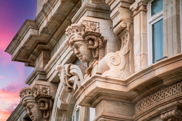 Detail of head sculpture of the facade of the city hall of Cartagena, Spain, modernist style