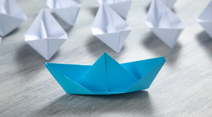 Blue and white paper boats. Business concept