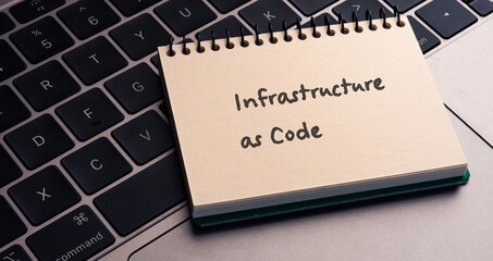 There is notebook with the word Infrastructure as Code.It is an abbreviation for Infrastructure as Code as eye-catching image.