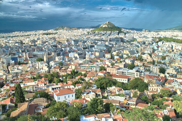 Fototapeta na wymiar View from Acropolis to Mount Lycabettus and stormy sky - Athens, Greece.