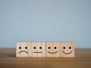 Wooden cube with many emotions icons Customer Satisfaction Rating Concept
