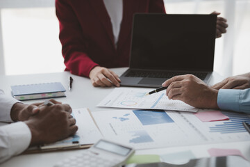 Atmosphere of a startup company meeting, business people are meeting together to summarize and plan investment finances, they are the founders of the company. Business administration concept.