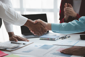Business investor group shakes hands, Two businessmen are agreeing on business together and shaking hands after a successful negotiation. Handshaking is a Western greeting or congratulation.