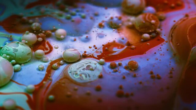 Beautiful colorful bubbles flowing in liquid paint. Abstract macro background. 