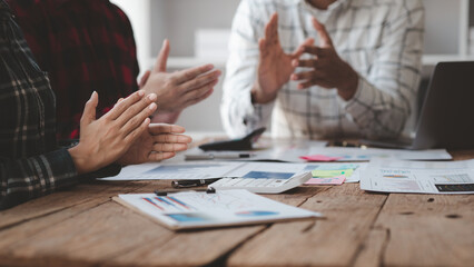 Meeting room atmosphere, business people meeting together on finance topics, they are working together to plan and solve corporate finance issues. Concept of business administration and finance.