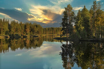 Bright summer sunset over the lake in the woods, Sweden around town Dorotea
