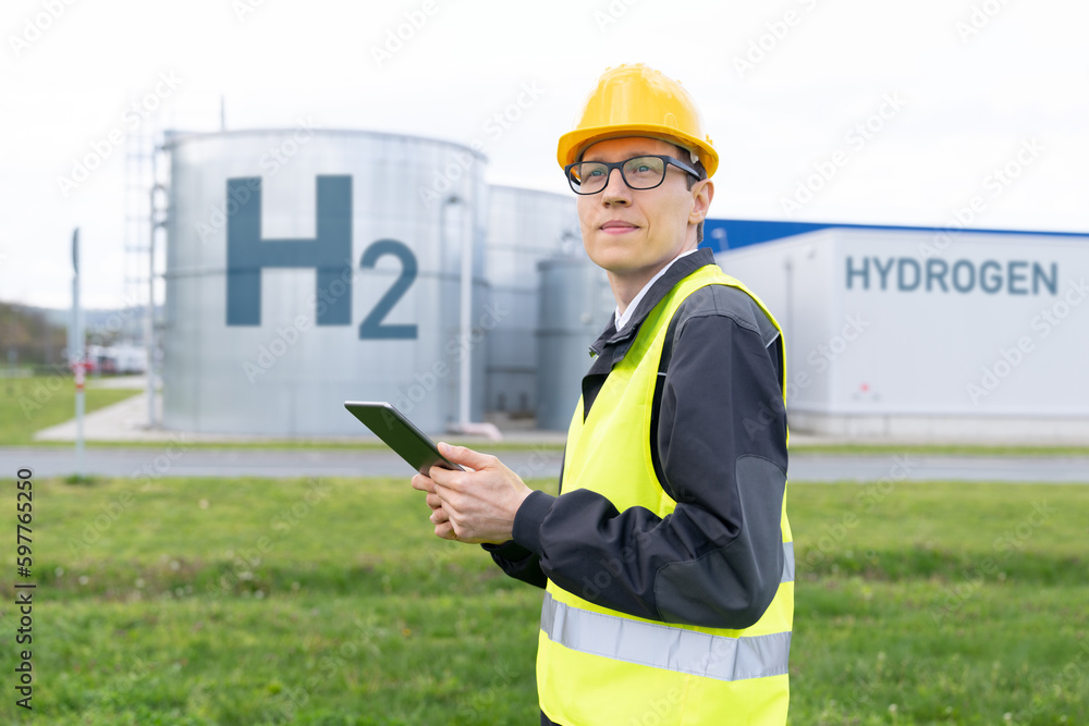 Poster Engineer with tablet computer on a background of Hydrogen factory	