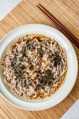 Korean food Naengmemilguksu, a winter delicacy, this buckwheat noodle dish is served in a cold chicken- or beef-based broth and topped with cold slices of beef and egg as a garnish.