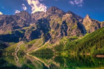 Beautiful clean lake in the Polish mountains in a summer, sunny scenery. Popular Polish Lake Marine Eye in High Tatra Mountains, Poland. © shadowmoon30