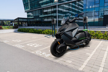 Electric scooter with charging station on a parking lot for LEV - light electric vehicles	