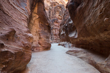 the narrowing sandstone gorge in Petra, Jordan