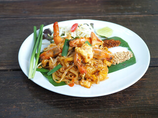 Pad Thai (Thai Fried Noodles) with shrimp and vegetables. Closeup photo, blurred.