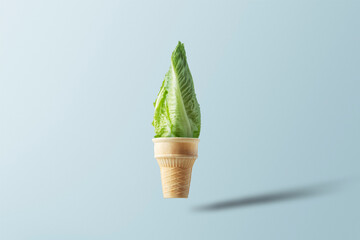 Creative concept for a healthy lifestyle. Waffle ice cream cup with lettuce leaves.