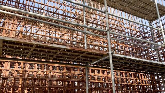 high-rise scaffolding around the reinforcing cage of a reinforced concrete structure