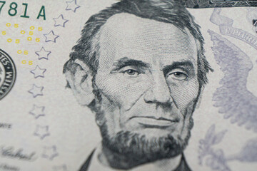 Macro shot Portrait of Abraham Lincoln on the one five dollar bill. Background of the money. 5 dollar bill with Abraham Lincoln eyes macro shot. Money background. Face portrait