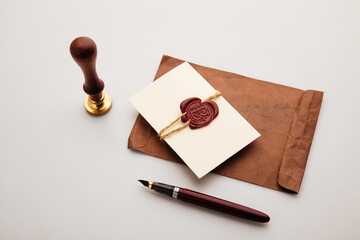 Paper envelope with wax stamp and pen