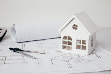 White house and engineer tools on blueprint house plan design. Building concept