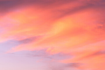 Sky with soft and fluffy pastel coral orange pink and blue colored clouds. Sunset background. Nature. sunrise. Instagram toned style