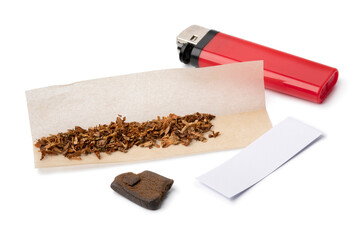 Ingredients for a joint with a piece of afghan hash on white background close up