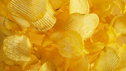 Potatoes chips flying up in the air.