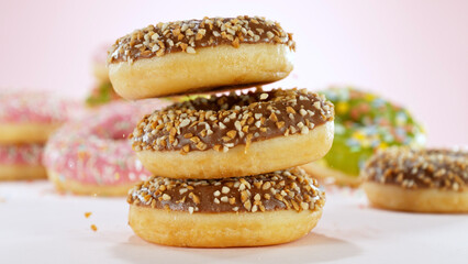 Stacking sweet chocolate donuts.