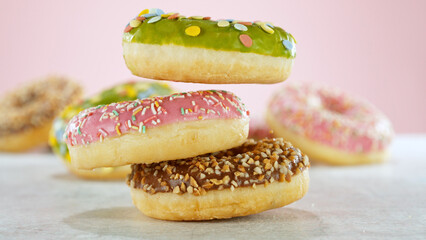 Stacking sweet colored donuts.