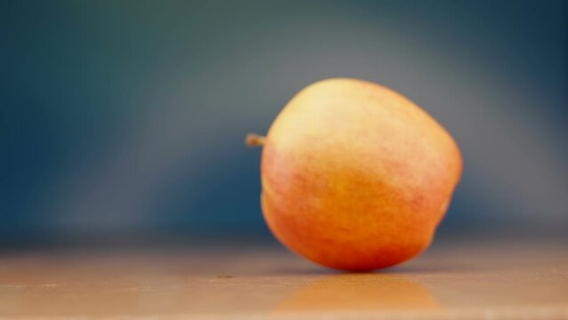A rolling apple on the wooden table as sen on a closer look in Estonia