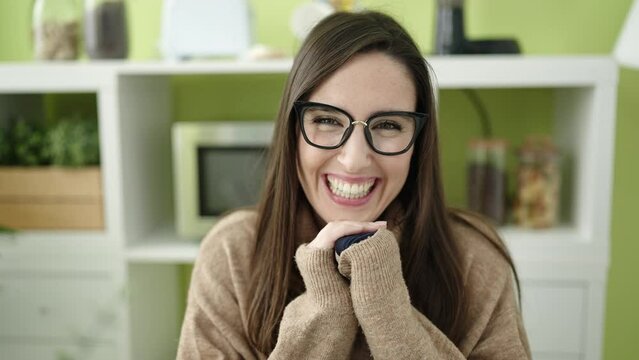 Beautiful hispanic woman smiling confident at dinning room