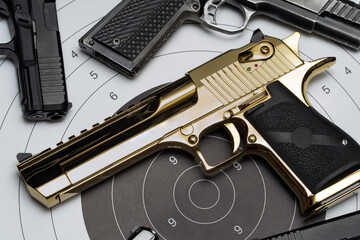 Weapon, a large pistol of gold color, close-up photo.