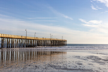 A view on the pier on the Pacific coast at sunset