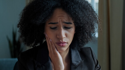 African girl businesswoman student woman with curly hairstyle suffer from toothache sick female...