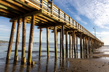 A view on the pier on the Pacific coast at sunset