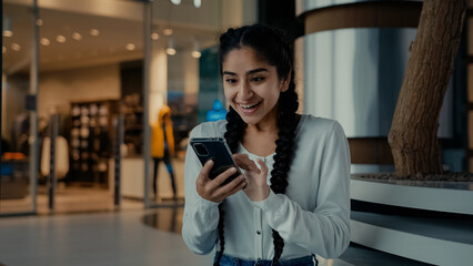 Emotional amazed winner arabian woman shopper use smartphone apps shopping online click on mobile phone screen win internet sales on Black Friday business achievement celebrate auction victory jackpot