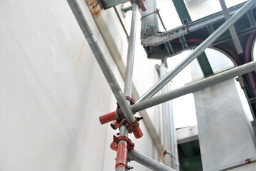 Scaffolding pipe clamp. Steel scaffolding and mounting parts for strength in construction sites . Close-up and select focus
- 597799806