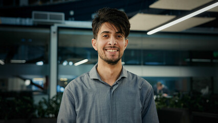 Portrait happy indian young man professional businessman entrepreneur agent manager stand in office confident smiling male looking at camera arabian ethnic guy business owner millennial posing indoors