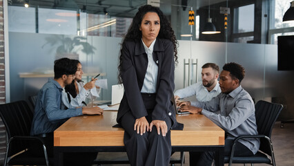 Worried upset leader woman tired worker businesswoman sitting on table in conference room sad with...
