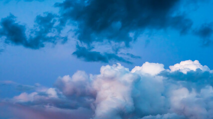 Fancy cumulus and dark clouds in blue sky